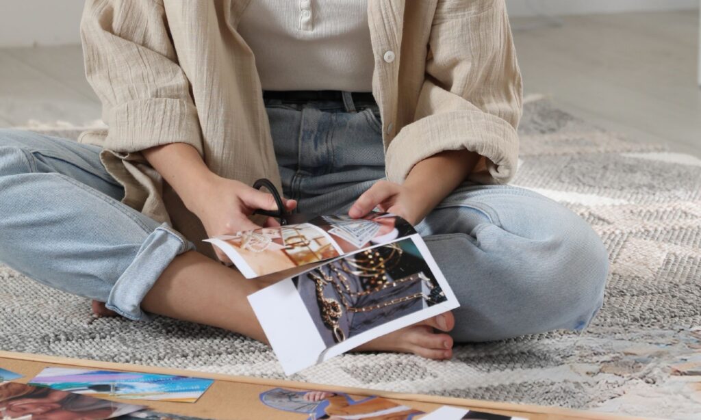 woman cutting magazine images to create a fashion vision board